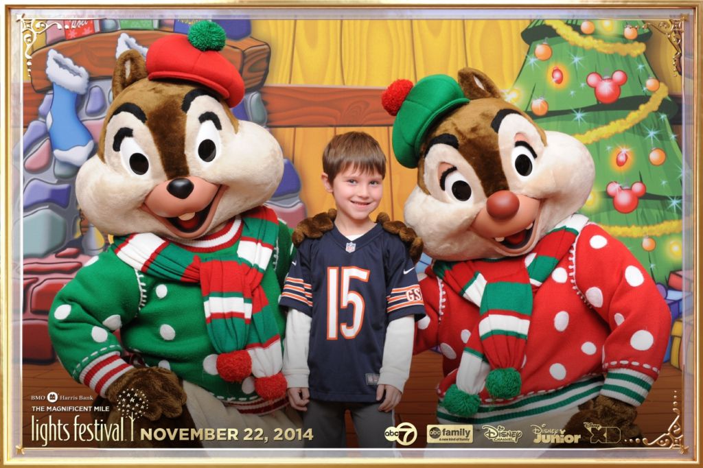 Little boy with Chicago Bears jersey poses with Disney chipmunks Chip and Dale for step repeat photography
