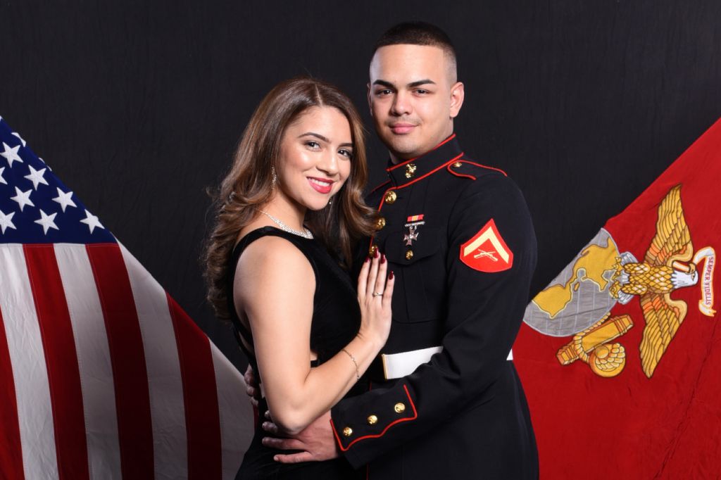 Attractive young couple receive step repeat formal portraits at marine ball