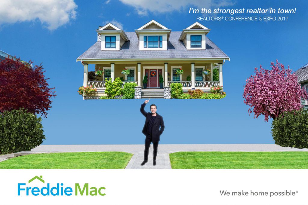 Strongest realtor in town holds up house one finger FreddieMac green screen photobooth