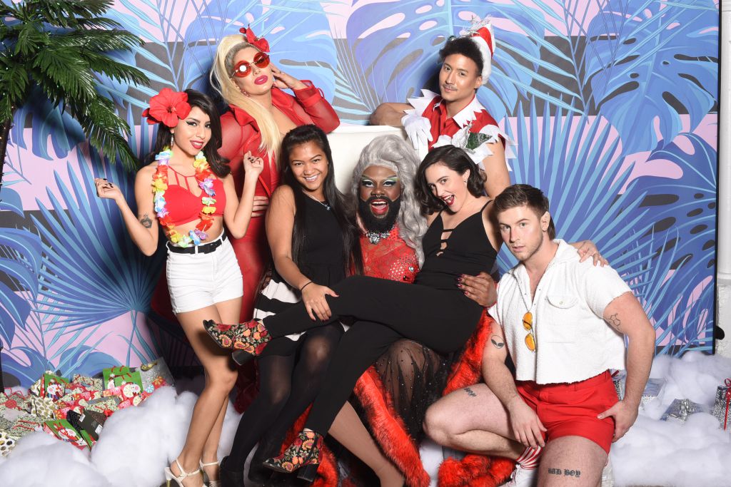 Lucy Stoole hosts GRINDR non traditional santa booth for corporate holiday party photos with Santa