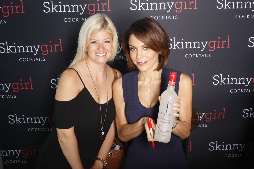 Skinny Girl Bethany Frankel signs bottles for fans who get photo printed onsite