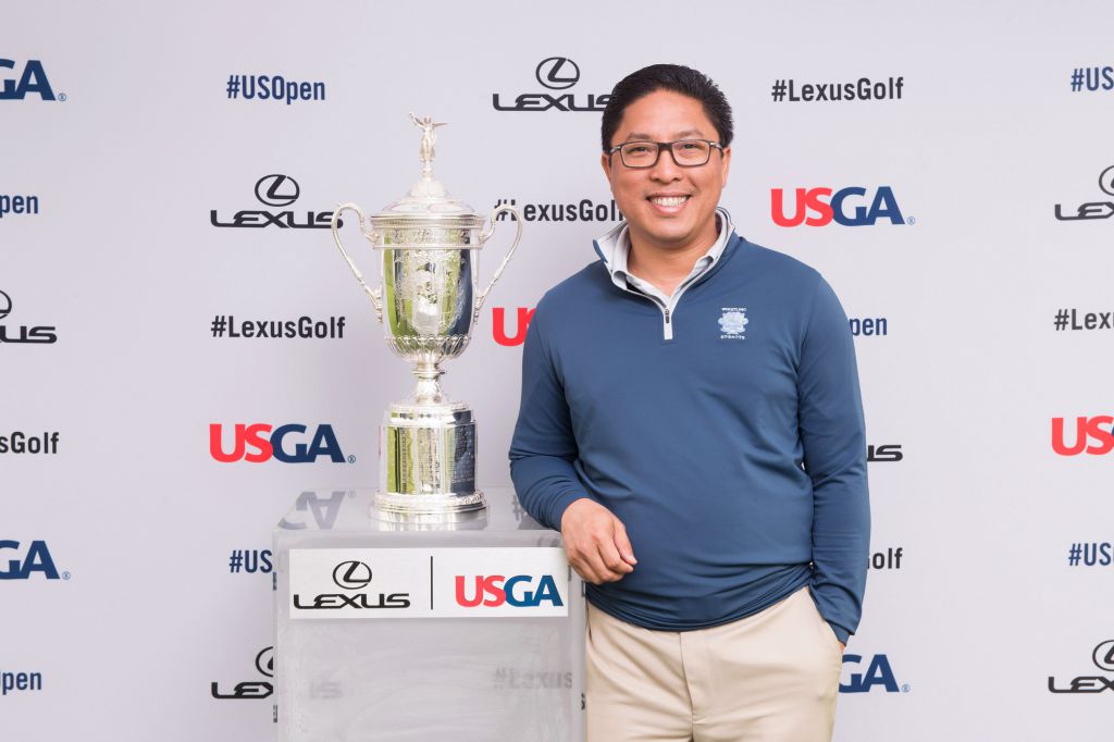 Guest at US Open gets photo op step and repeat photography with PGA trophy