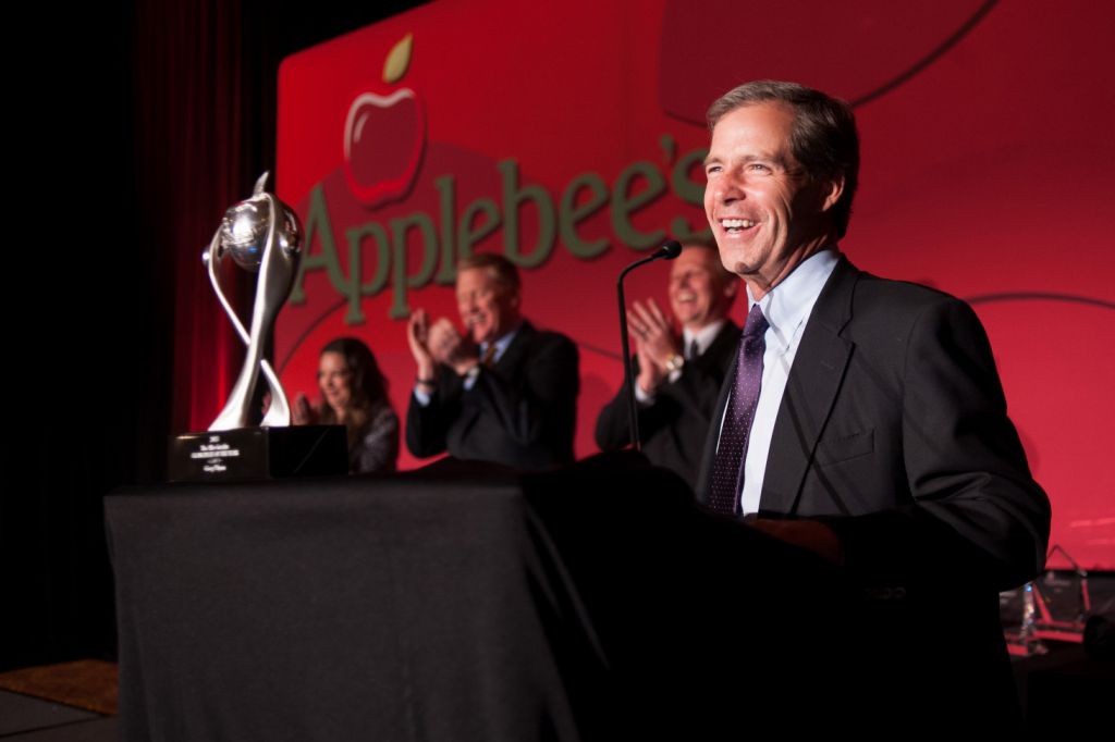 Applebes CEO photographed at podium during awards dinner
