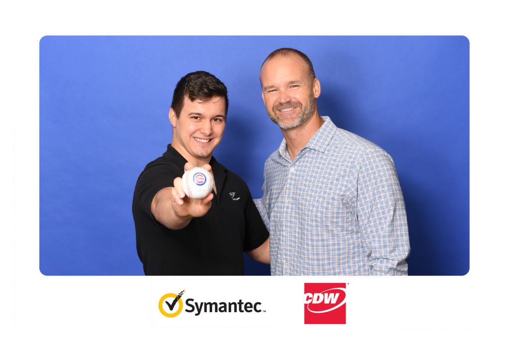 Fan poses for step repeat photo with David Ross