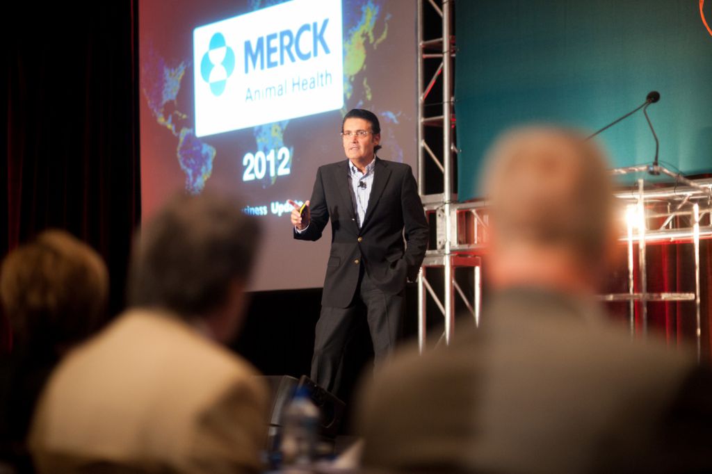 Speaker addresses audience from stage at annual sales meeting