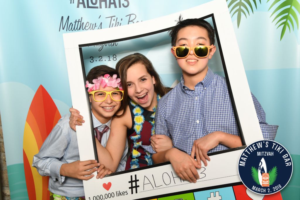 Kids pose in instagram photo prop frame on step repeat photo background for Chicago Bar Mitzvah