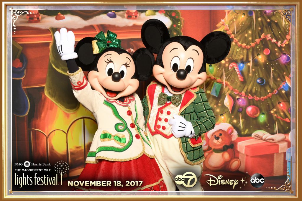 Mickey and Minnie Mouse pose on the step repeat background for Disney Character Meet Greet Chicago event