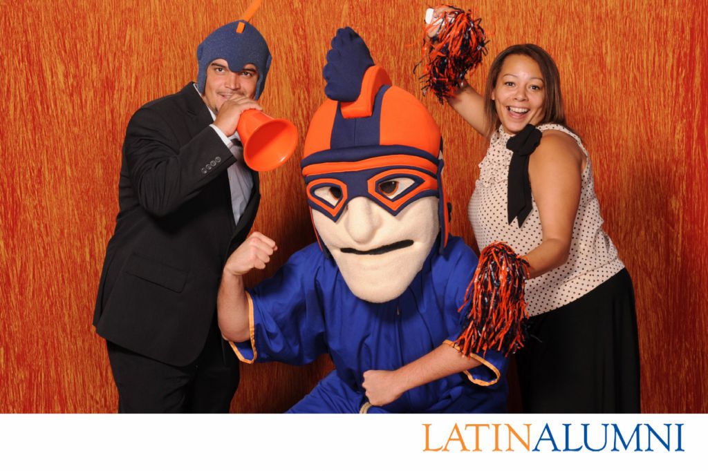 The Chicago Latin School Roman mascot poses with alumni who get 4x6 photo prints at reunion event