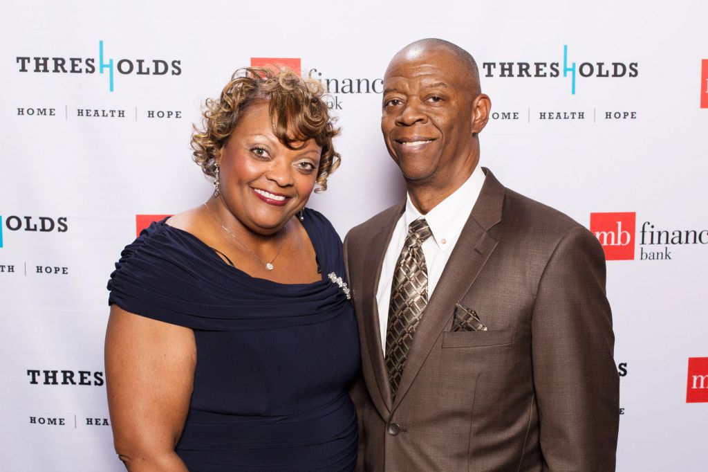 Handsome couple poses on step repeat photo op at Thresholds fundraising gala Chicago