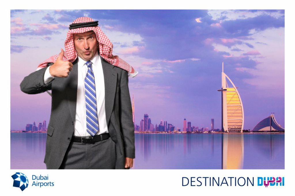 Thumbs up from man dressed like Sheik by Burj Al Arab Dubai, 4x6 photo souvenir printed at tradeshow